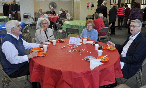 4 people eating soup